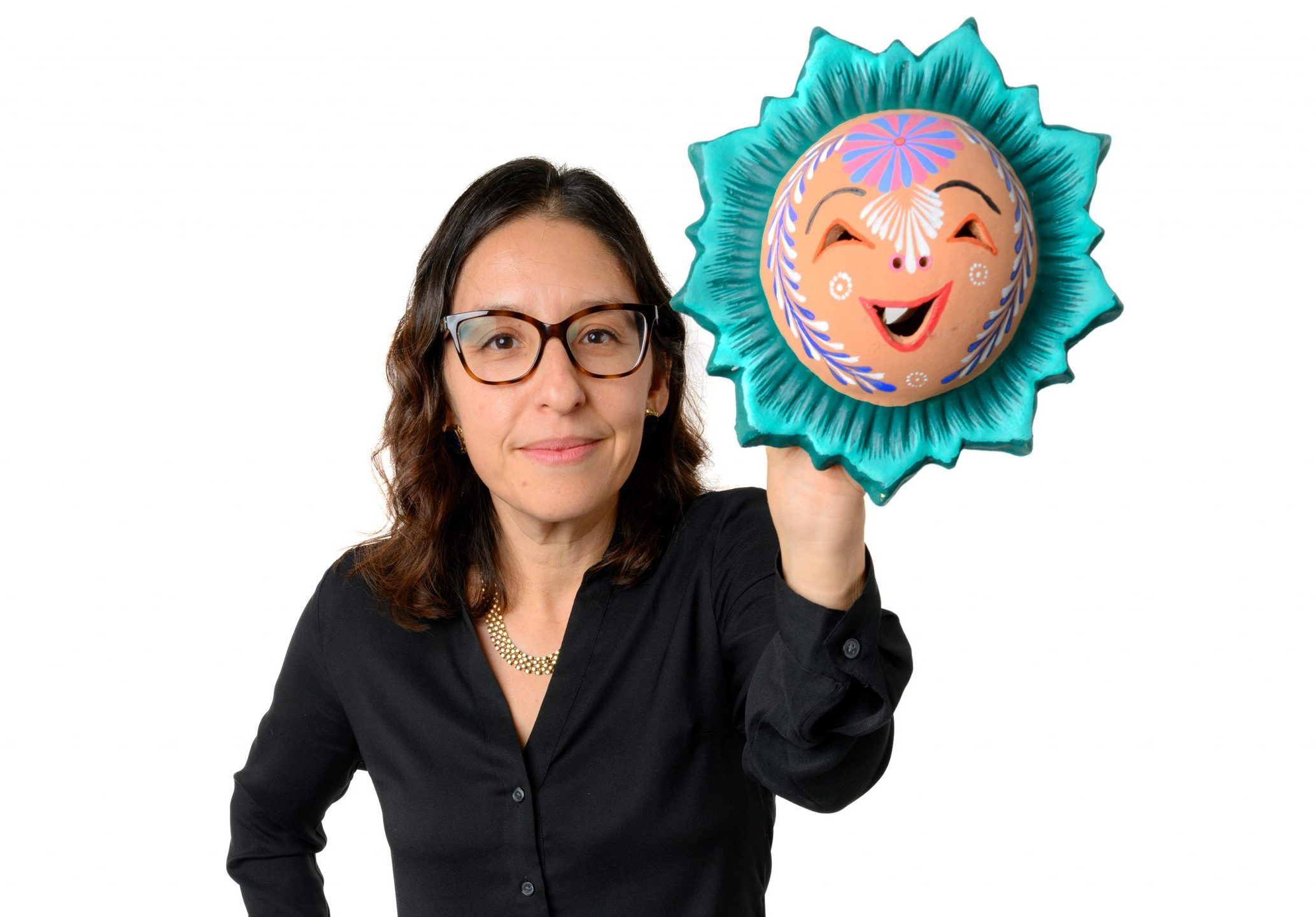 Dr. Gabriela Livas Stein with a Latinx art piece