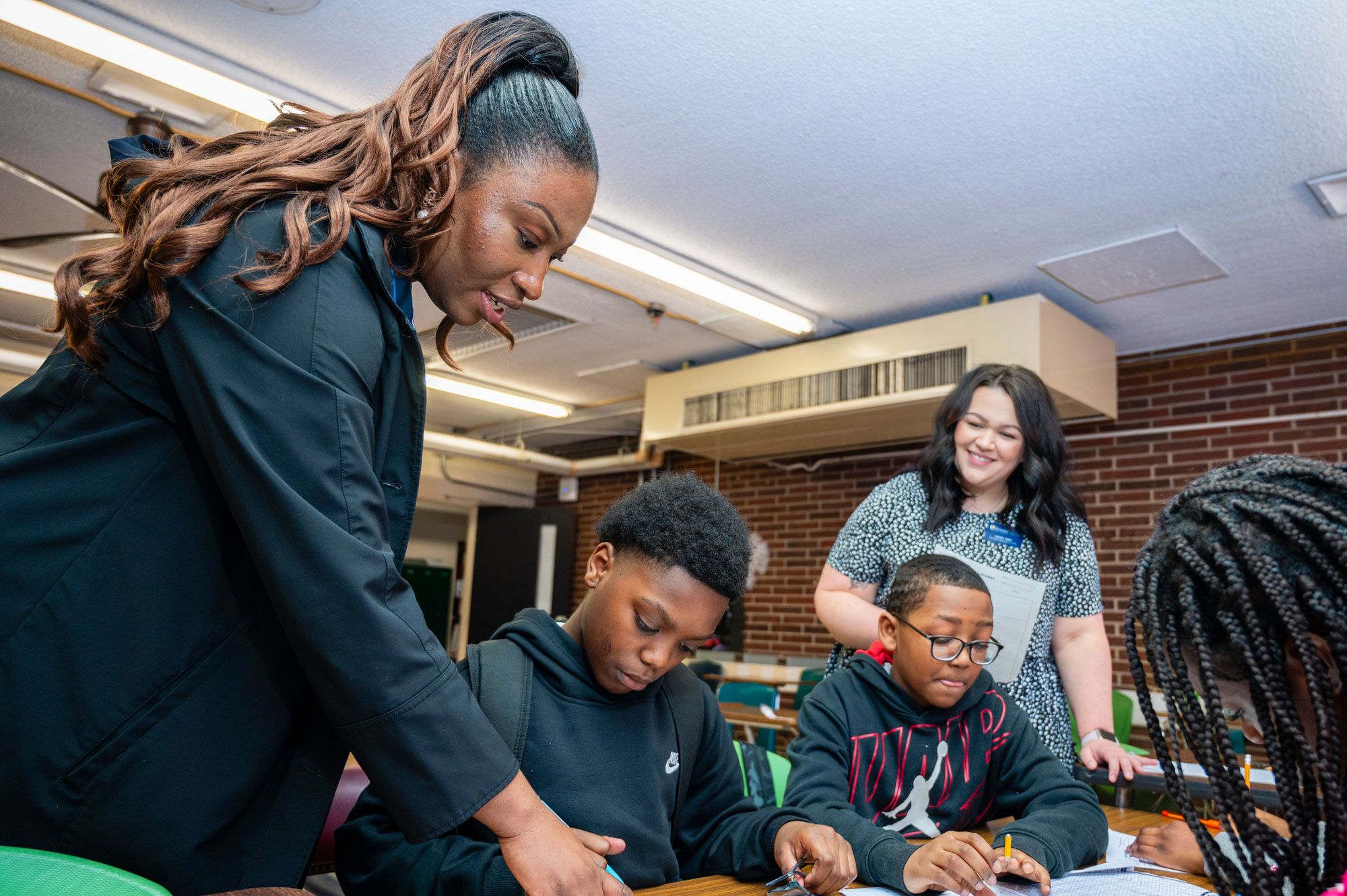 A teacher pointing to a student's work