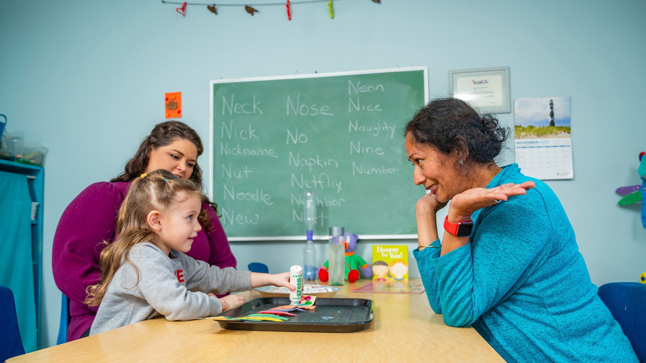 Amanda Flynt at KinderNest Preschool with student and teacher