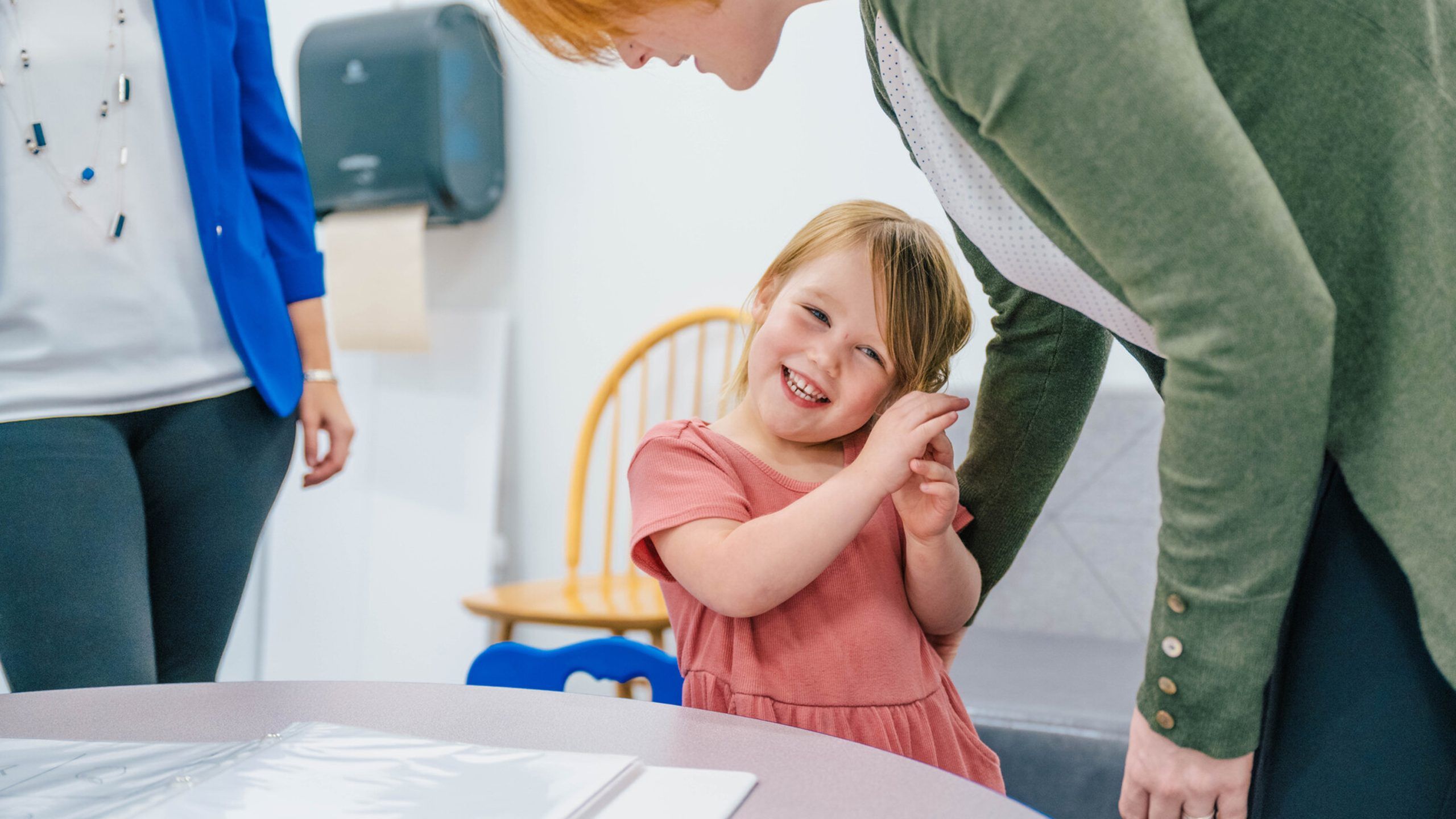A toddler smiling with Sattler and Leerkes