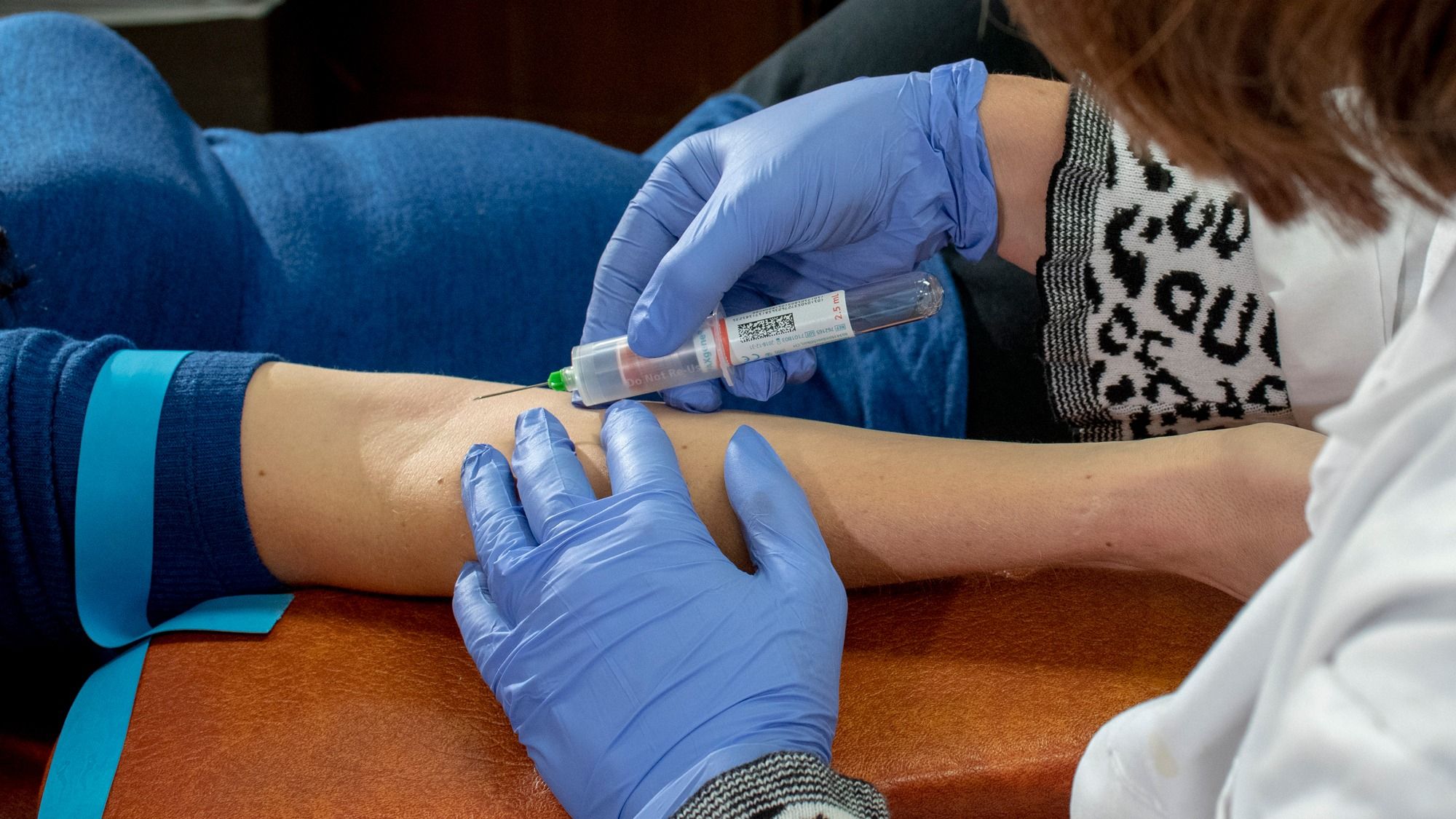 Researcher drawing blood